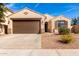 Charming single-story home with a brown two car garage, desert landscaping and a walkway to the front door at 4639 E Cabrillo Dr, Gilbert, AZ 85297