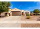 Charming single-story home with a brown two car garage, desert landscaping and a walkway to the front door at 4639 E Cabrillo Dr, Gilbert, AZ 85297