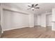 An empty living room featuring a ceiling fan, base trim, and light hardwood floors at 4639 E Cabrillo Dr, Gilbert, AZ 85297