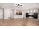 Open-concept layout with wood-look floors connecting the living room, kitchen, and dining area at 4639 E Cabrillo Dr, Gilbert, AZ 85297