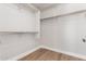 Spacious walk-in closet with ample shelving and storage options with sleek wood flooring at 4639 E Cabrillo Dr, Gilbert, AZ 85297