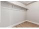 Empty walk-in closet with shelves and ample room for organizing clothes and accessories and wood flooring at 4639 E Cabrillo Dr, Gilbert, AZ 85297