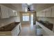 Bright kitchen featuring white cabinets, tile flooring and access to backyard at 4721 N 55Th Dr, Phoenix, AZ 85031