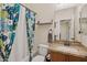 Bathroom featuring wood cabinets, granite countertops, and a bathtub shower combo at 4772 E Portola Valley Dr # 102, Gilbert, AZ 85297