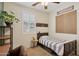 Bedroom with a ceiling fan, white shutters, and neutral colored walls and carpet at 4772 E Portola Valley Dr # 102, Gilbert, AZ 85297