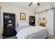 Cozy bedroom featuring a ceiling fan, sliding barn door to en-suite bath, and plenty of shelf space at 4772 E Portola Valley Dr # 102, Gilbert, AZ 85297