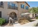Charming townhouse featuring stone accents, a cozy patio, and a balcony for enjoying the outdoors at 4772 E Portola Valley Dr # 102, Gilbert, AZ 85297