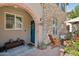 Inviting front porch with brick-paved patio and comfortable seating, great for relaxing and enjoying the neighborhood at 4772 E Portola Valley Dr # 102, Gilbert, AZ 85297