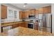 Well-equipped kitchen featuring granite countertops, stainless steel appliances, and ample cabinetry at 4772 E Portola Valley Dr # 102, Gilbert, AZ 85297