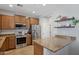 Modern kitchen featuring stainless steel appliances, granite counters, and ample storage at 4772 E Portola Valley Dr # 102, Gilbert, AZ 85297