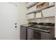 Laundry room featuring front load washer and dryer, white wire shelving, and a white door at 4772 E Portola Valley Dr # 102, Gilbert, AZ 85297