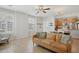 Spacious living room with neutral walls, plantation shutters, tile floors and seamless access to kitchen and dining at 4772 E Portola Valley Dr # 102, Gilbert, AZ 85297