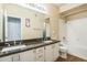 Bathroom with double sinks, granite counters, and white cabinets at 5401 E Van Buren St # 3048, Phoenix, AZ 85008