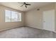 This bedroom features ample natural light, ceiling fan, and neutral carpet at 5401 E Van Buren St # 3048, Phoenix, AZ 85008