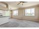 Dining area with large windows adjacent to the living room and kitchen at 5401 E Van Buren St # 3048, Phoenix, AZ 85008
