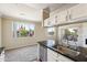 Open-concept kitchen featuring granite countertops, stainless steel appliances, and a view of the neighborhood at 5401 E Van Buren St # 3048, Phoenix, AZ 85008