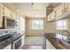 Open kitchen adjacent to dining area with stainless steel appliances at 5401 E Van Buren St # 3048, Phoenix, AZ 85008