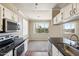 Well-lit kitchen with granite countertops, white cabinetry, and modern appliances, creating a functional space at 5401 E Van Buren St # 3048, Phoenix, AZ 85008