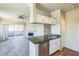 Kitchen area with granite counters adjacent to the living room and fireplace at 5401 E Van Buren St # 3048, Phoenix, AZ 85008