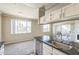 Kitchen sink with granite counters overlooks the dining and living spaces at 5401 E Van Buren St # 3048, Phoenix, AZ 85008