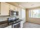 Kitchen has stainless steel appliances and is adjacent to the dining area at 5401 E Van Buren St # 3048, Phoenix, AZ 85008