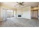 Living room with a sliding glass door that opens to the patio and a fireplace at 5401 E Van Buren St # 3048, Phoenix, AZ 85008