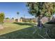 Spacious backyard with mature trees, storage shed, and block fence providing privacy at 5437 E Pinchot Ave, Phoenix, AZ 85018