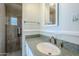 Bathroom featuring a granite countertop and a tiled shower with a built-in niche at 5437 E Pinchot Ave, Phoenix, AZ 85018