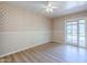 Bedroom with a ceiling fan, neutral wallpaper, and sliding doors to the exterior at 5437 E Pinchot Ave, Phoenix, AZ 85018