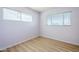 This bedroom features a window and light hardwood flooring at 5437 E Pinchot Ave, Phoenix, AZ 85018