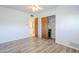 This bedroom has neutral colored tile flooring, a closet and an open door at 5437 E Pinchot Ave, Phoenix, AZ 85018