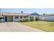 Single-story home with a large driveway, desert landscaping, and blue trim at 5437 E Pinchot Ave, Phoenix, AZ 85018