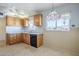 Kitchen with light cabinets, a double sink, and a window at 5437 E Pinchot Ave, Phoenix, AZ 85018