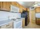 Bright kitchen with light wood cabinetry, white countertops and black appliances at 5437 E Pinchot Ave, Phoenix, AZ 85018