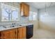 Kitchen with a stainless steel sink, black dishwasher and tile floor at 5437 E Pinchot Ave, Phoenix, AZ 85018