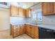Kitchen with light wood cabinets, black dishwasher, and double sink at 5437 E Pinchot Ave, Phoenix, AZ 85018