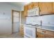 Classic kitchen featuring white appliances and light wood cabinets at 5437 E Pinchot Ave, Phoenix, AZ 85018