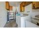 Functional laundry room with washer, dryer, utility sink, and ample storage cabinets at 5437 E Pinchot Ave, Phoenix, AZ 85018