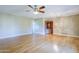 Bright living room with light wood floors, a ceiling fan, and built-in cabinet at 5437 E Pinchot Ave, Phoenix, AZ 85018