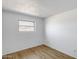 Bright bedroom featuring wood-look floors, white walls, and a window offering natural light at 5504 N 69Th Ave, Glendale, AZ 85303