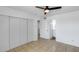 Cozy bedroom with sliding closet doors, tiled floor, ceiling fan, and a door to the bathroom at 5504 N 69Th Ave, Glendale, AZ 85303