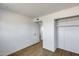 Bedroom with closet, wood-look floors, and white walls, open to the doorway at 5504 N 69Th Ave, Glendale, AZ 85303