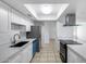 Bright kitchen featuring stainless steel appliances, white cabinets, and a skylight at 5504 N 69Th Ave, Glendale, AZ 85303
