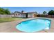 Backyard showcasing an in-ground swimming pool with concrete surround and rear pool house at 5504 N 69Th Ave, Glendale, AZ 85303
