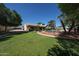 Lush backyard with a sparkling pool, mature trees, and ample space for outdoor relaxation and entertainment at 5521 W Northwood Dr, Glendale, AZ 85310