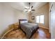 Cozy bedroom with a ceiling fan, a small window, and ceramic tile flooring at 5521 W Northwood Dr, Glendale, AZ 85310