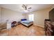 Cozy bedroom featuring tiled floors, ceiling fan, and window for natural light at 5521 W Northwood Dr, Glendale, AZ 85310