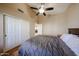Comfortable bedroom featuring a ceiling fan, a closet, and ceramic tile flooring at 5521 W Northwood Dr, Glendale, AZ 85310