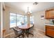 Bright breakfast nook features a table, chairs, and large windows with a view of the pool at 5521 W Northwood Dr, Glendale, AZ 85310