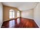 Sunlit room boasts wood floors, vaulted ceilings, and arched windows creating an inviting atmosphere at 5521 W Northwood Dr, Glendale, AZ 85310